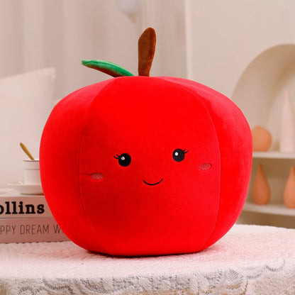 Red apple-shaped plush toy with a smiling face on a neutral background