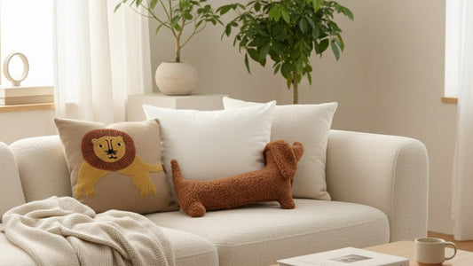 Cute plush dachshund pillow in brown boucle fabric on cream sofa in Scandinavian living room - ultra-soft elongated dog pillow for modern home decor