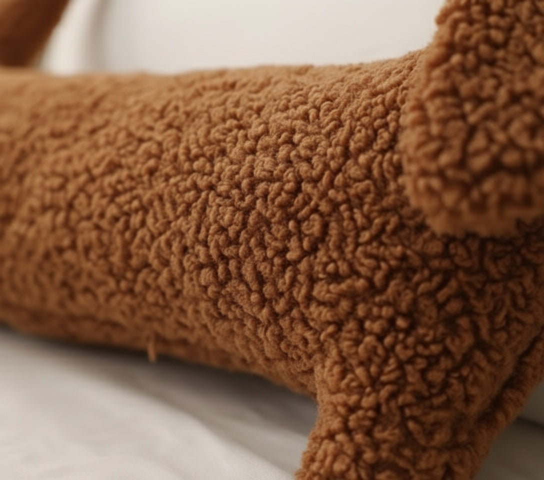 Close-up of brown boucle teddy fabric texture on cute dachshund pillow showing premium craftsmanship and ultra-soft plush material
