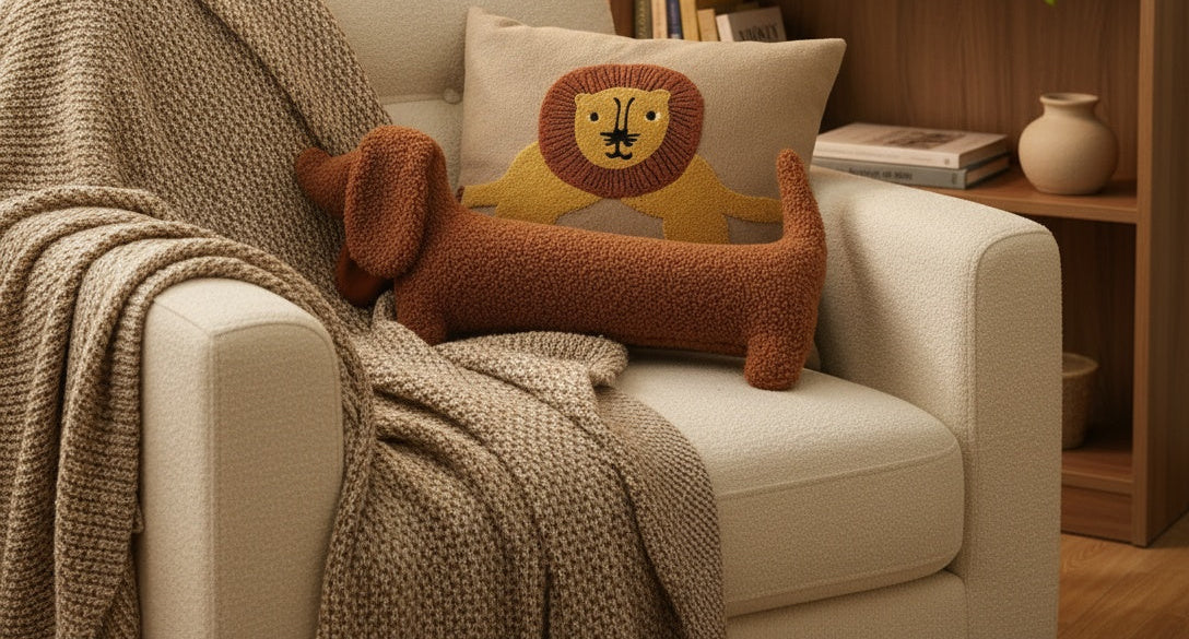 Plush dachshund pillow in cozy reading nook with armchair - ultra-soft elongated dog pillow for bedroom and living room comfort
