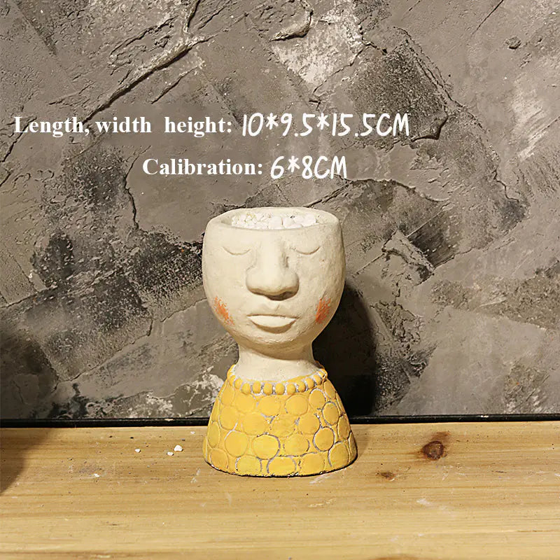 Decorative pot shaped like a face with measurements on a stone background